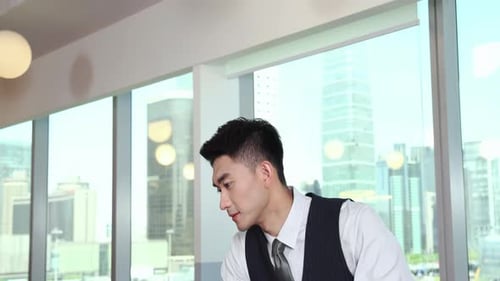 Handsome business people businessman in formal suit working in the modern office space sitting by wi