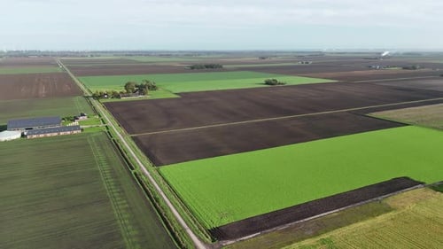 Agricultural land farmland aerial with green fields and farm