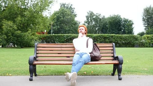 Relax Beard Man Thinking While Sitting in Park on Bench Red Hairs