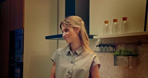 Smiling Woman in a Warmly Lit Kitchen