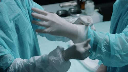 Doctors Wear Surgical Gloves in Hospital Preparation