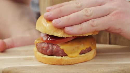 Making American Fat Smash Burger with Fresh Tomatoes and Cheese on Grill Closeup Macro Beef or Pork
