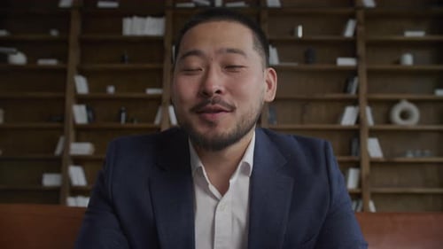 Man in Suit Jacket Talking Indoors
