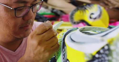 One Of The Last Paper Dragon Masters Of Hong Kong, Painting Design Onto Hand Made Dragon. Slow Mo...