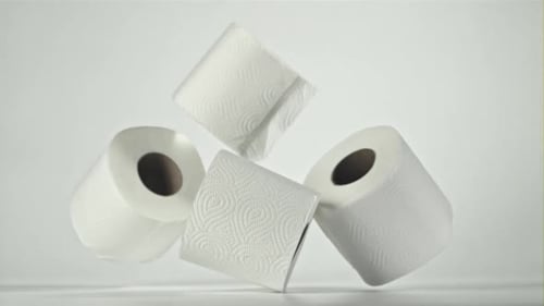 White Rolls of Toilet Paper Falling