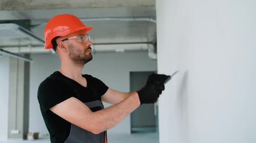 Construction Worker Smoothing Wall with Trowel
