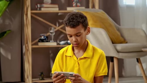 Child Focused on Smartphone Game Indoors