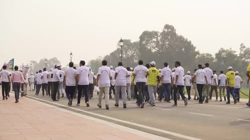 Adults Walking Together on Road in Urban Park