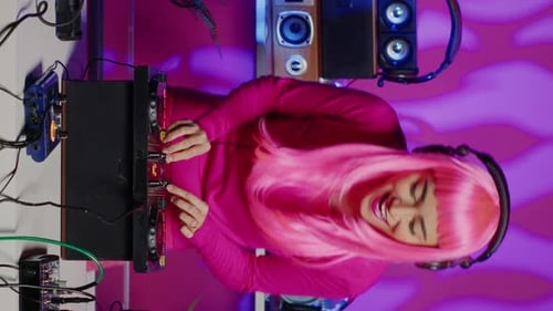 Vertical Video Smiling Performer Dancing and Mixing Techno Sound