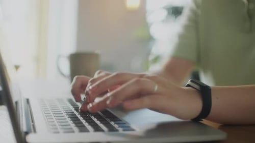 Woman Typing on Laptop at Home Office Desk