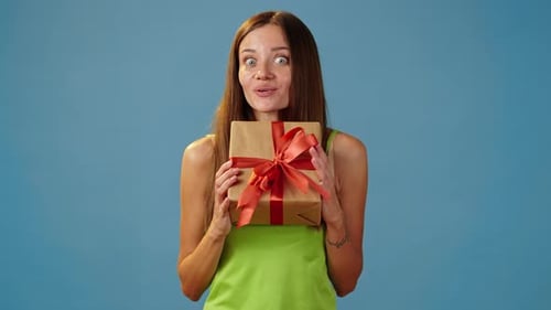 Pleased Woman Receiving Gift Box with Red Ribbon
