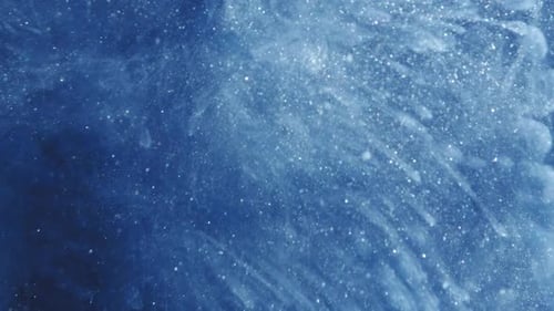 Glittering White Particles Flowing on Blue Backdrop