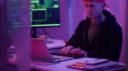 Young Adult Typing on Computer Keyboard at Night