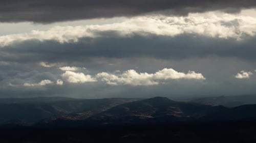 Illuminated Clouds in Dark Storm Over Landscape Timelapse