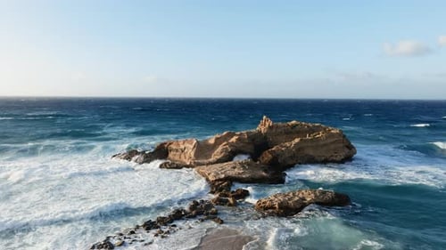 Sun Over the Sea Waves Crashing Into Rocks