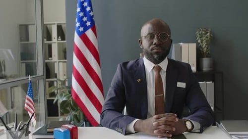 Portrait of Serious Black Male Consular Worker Posing in US Embassy