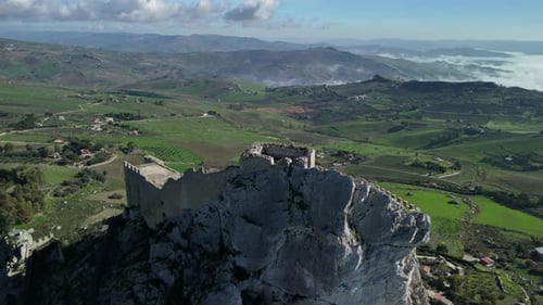 Stunning Aerial View of Ancient Castle atop a Rocky Cliff