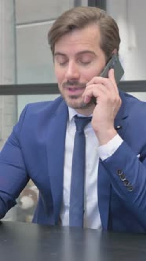 Professional Man Talking on a Cell Phone at Work