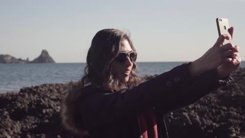 Woman Takes Selfie at the Rocky Beach