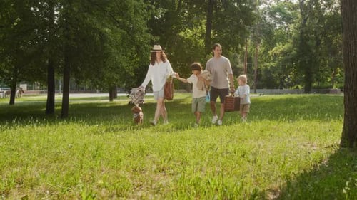 Slow Motion of Family of Four Heading to Park for Picnic