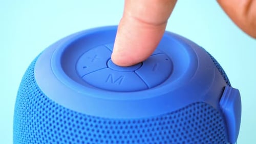 Finger Press the Button to Turn on Smart Speaker