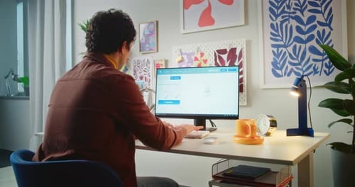 Young Man Types Prompt in AI Video Generator on Personal Computer