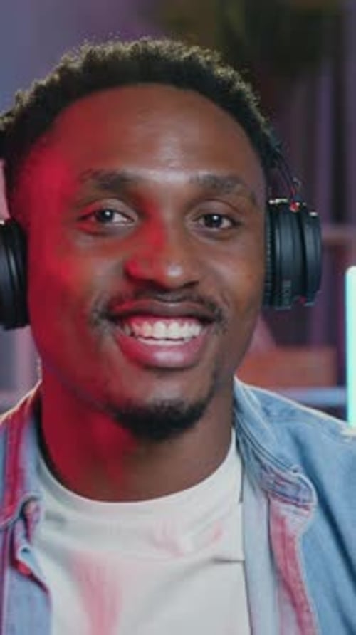 Close View of Likable Satisfied Modern Relaxed African American Man in Earphones Which Enjoying