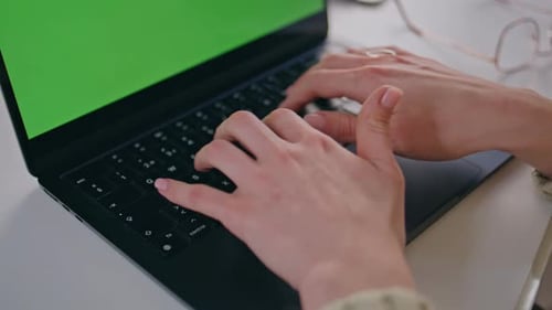 Woman's Hands Typing on Laptop Green Screen