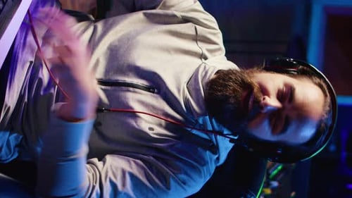 Bearded Man with Headphones and Expressive Hands