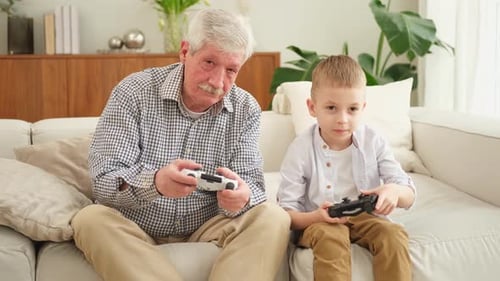 Grandfather and Grandson Playing Video Games Together