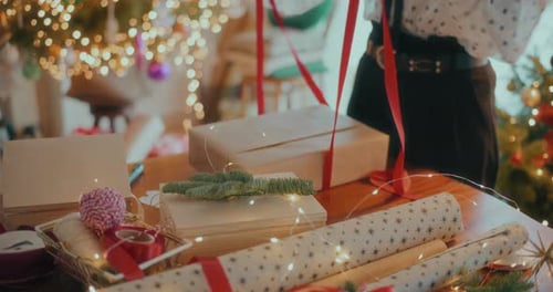 Woman Wrapping Christmas Gift at Home