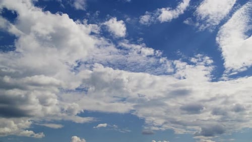 Strahlend blauer Himmel mit flauschigen weißen Wolken im Zeitraffer