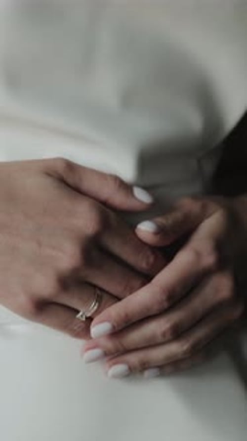 Close Up of Hands Wearing Diamond Wedding Ring