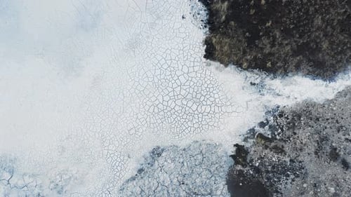 Dried up white silica mud at run off pool from geothermal power plant, top down