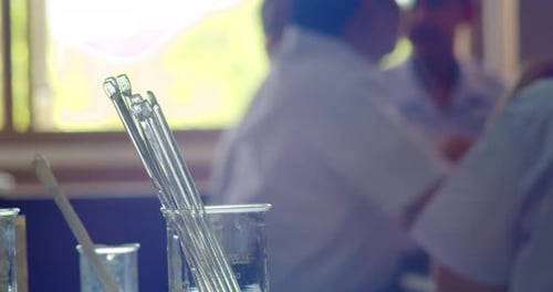Laboratory Glassware and Students in Background