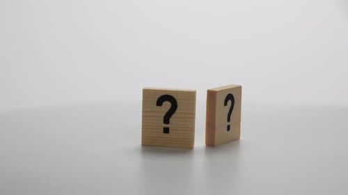Two wooden blocks with a question mark on them