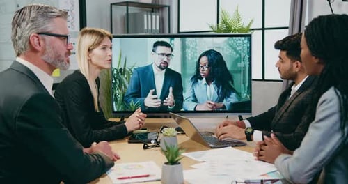 Diverse Team Video Conference in Modern Office