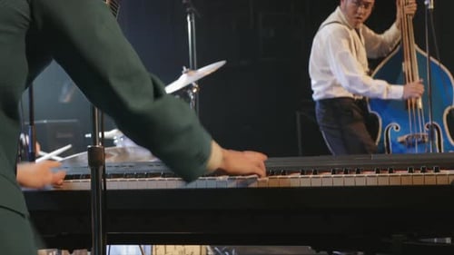 Rock Group Playing Piano and Double Bass on Stage in Nightclub Arts Entertainment