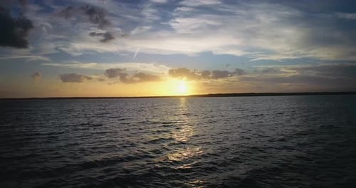 Flying Toward The Sun Over Water - 4K