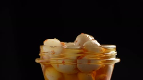 Preserved Garlic Cloves in Transparent Jar, Close-up