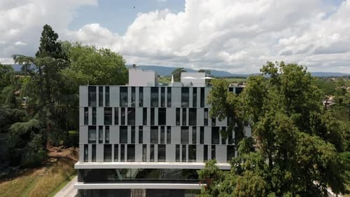 Jib up of a beautiful apartment building with a terrace on the rooftop in a small suburban town