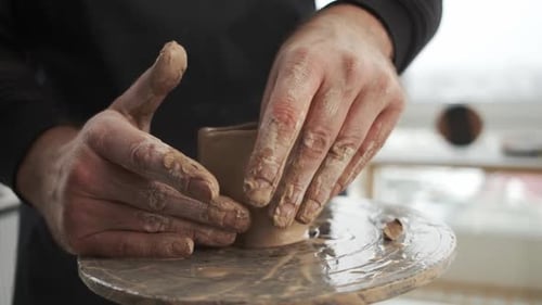 Man Creating Clay Pot on Wheel