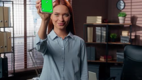 Woman Holding Phone With Green Screen Display