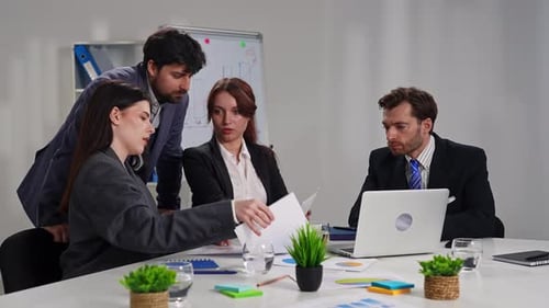 Business Meeting with Four People in Office Setting