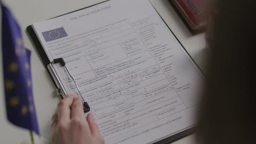 Approving Schengen Visa Application Form with Green Official Stamp