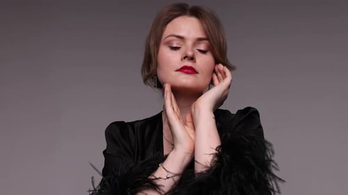 Elegant Woman in Sophisticated Black Outfit Posing in Studio