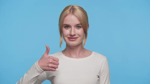 Woman Giving a Thumbs Up on Blue Background