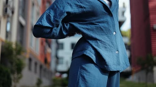 Woman In Blue Outfit in Urban Setting