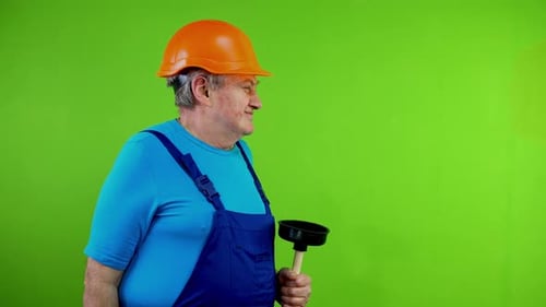 Man in Hard Hat Smells a Sink Plunger