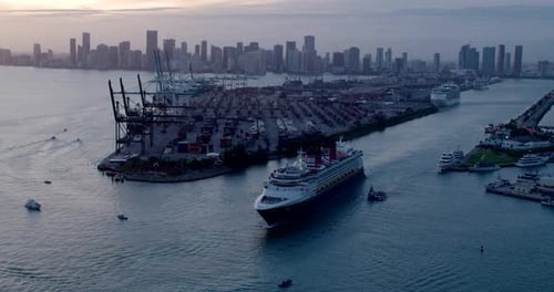 Miami Florida cruise ship sails into sunset from port aerial drone view
